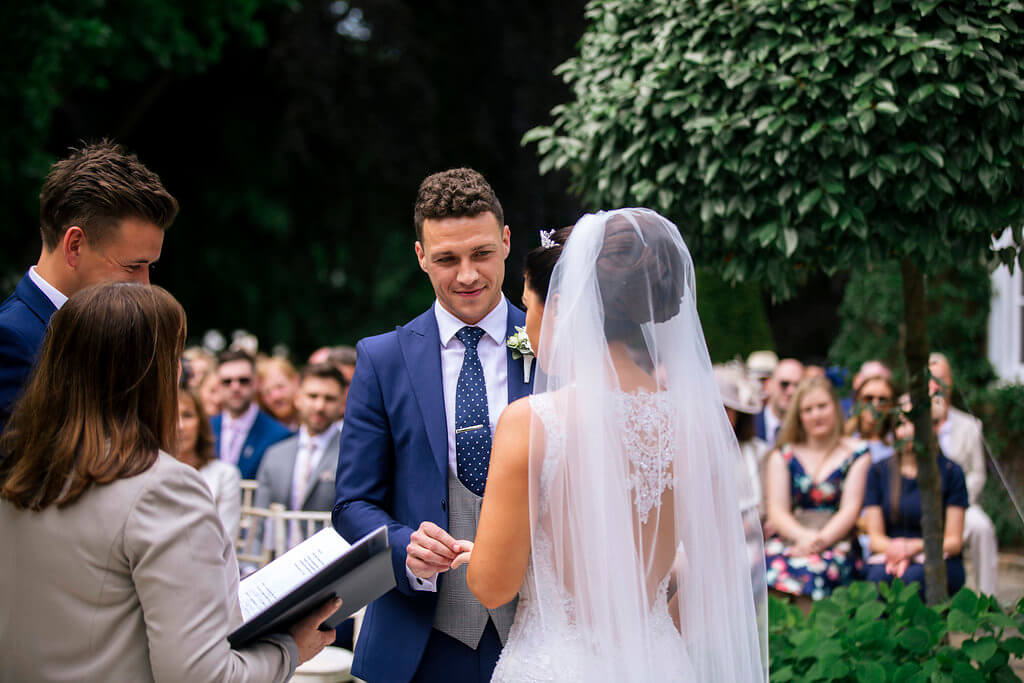 A candid shot of the bride and groom during the wedding ceremony.