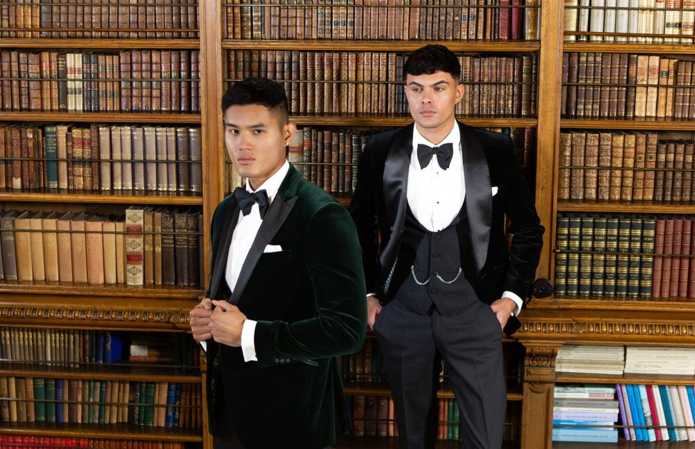 Bespoke black velvet dinner suit with traditional black velvet tux jacket, classic black dinner suit trousers and black horseshoe shape waistcoat. Features a slim fit 1 button velvet dinner jacket with wide black satin peak lapel. Worn with white studded dress shirt with French cuff shirt and large tom ford style bow tie and white pocket square. Bespoke green velvet dinner suit with traditional black velvet tux jacket, classic black dinner suit trousers and black horseshoe shape waistcoat. Features a slim fit 1 button velvet dinner jacket with wide black satin peak lapel. Worn with white studded dress shirt with French cuff shirt and large tom ford style bow tie and white pocket square
