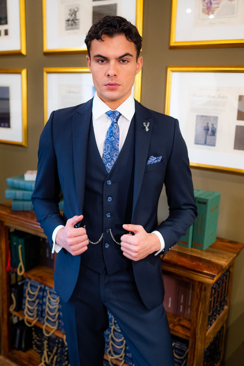 Slim fit navy suit in light weight, 100% wool. 3 piece navy suit with matching navy jacket, navy trousers and navy single breasted waistcoat. Features a slim fit 1 button jacket with classic peak lapel. Worn with white French cuff shirt and coordinating blue silk tie and pocket square.